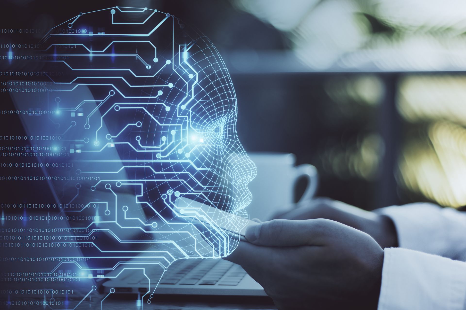 AI wireframe face over a laptop — human and machine intelligence
