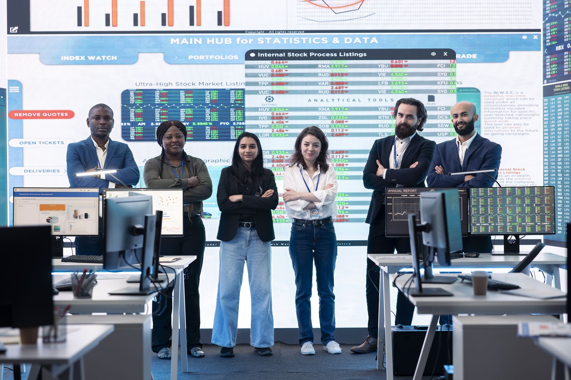 Analytics team in front of a large data wall